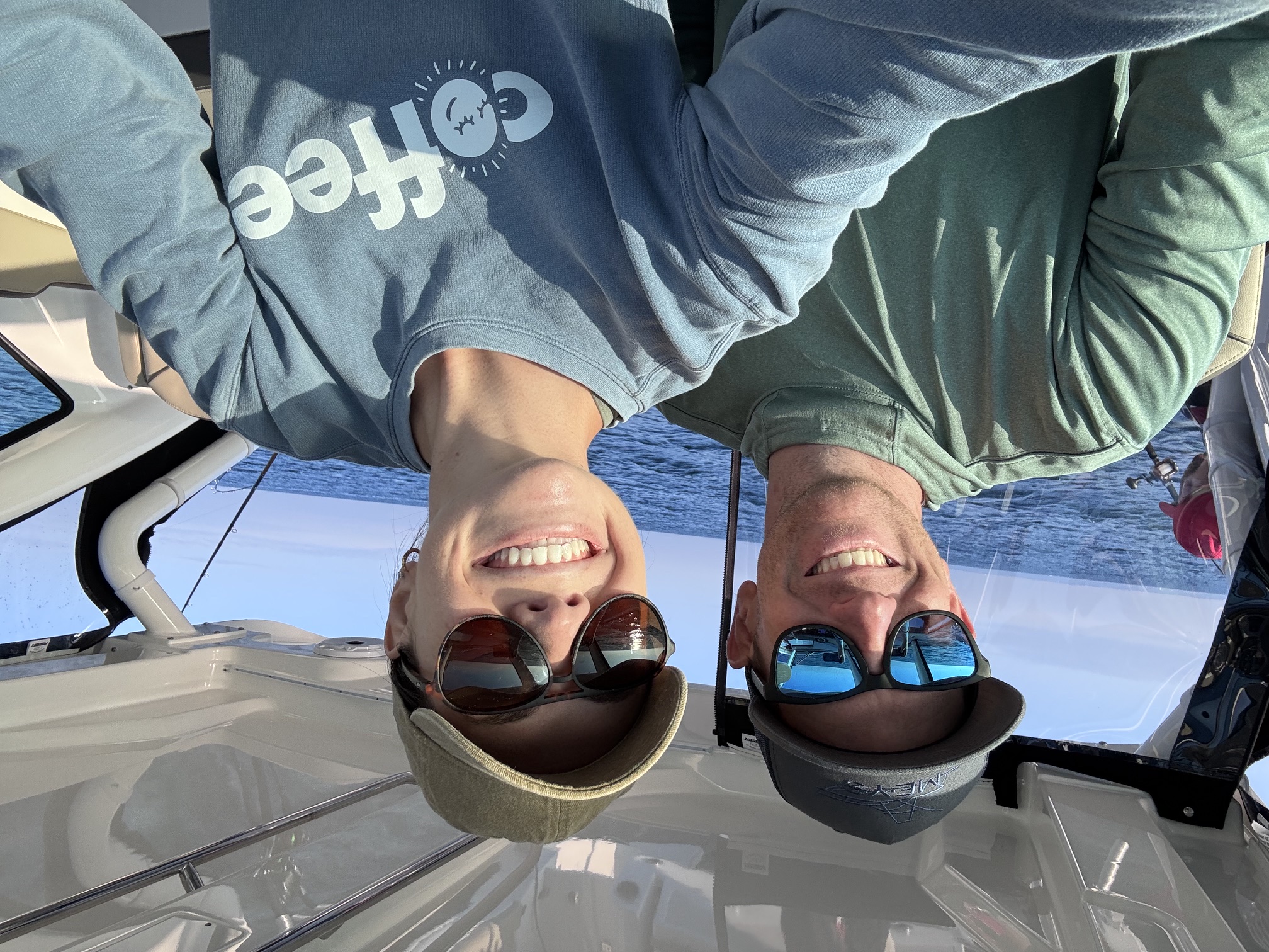 Austin and his wife smiling together on a boat